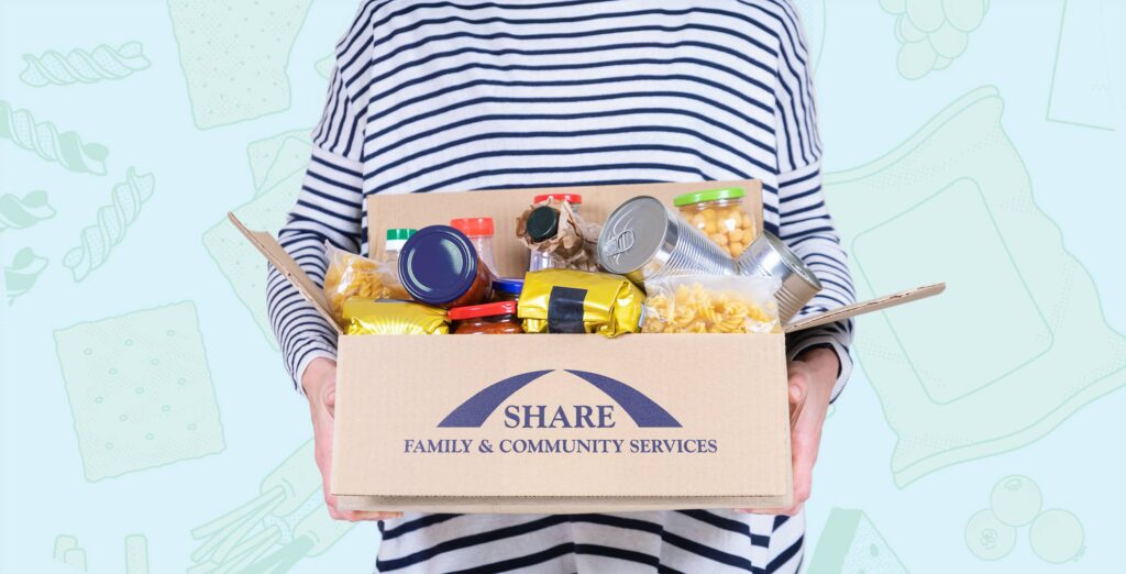 Person holding a SHARE Family & Community Services food hamper filled with donated food against a custom illustrated campaign background.